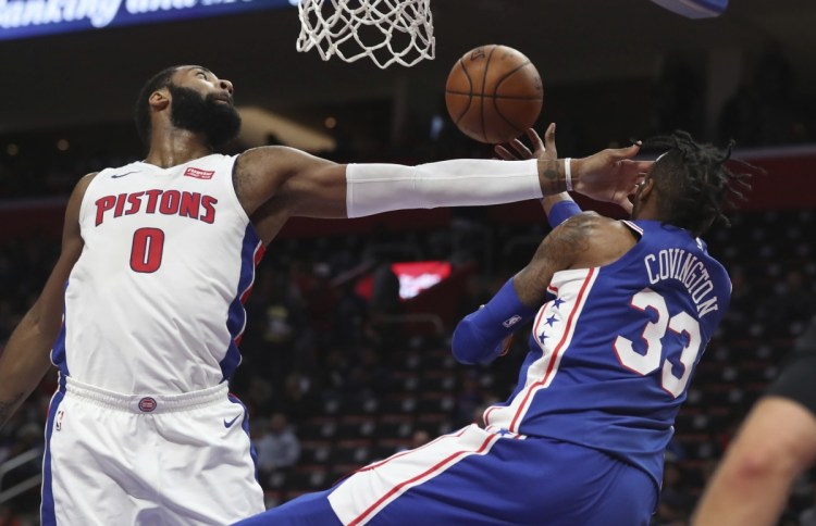 Philadelphia 76ers forward Robert Covington (33) passes as Detroit Pistons center Andre Drummond (0) defends during the second half of an NBA basketball game, Wednesday, April 4, 2018, in Detroit. (AP Photo/Carlos Osorio)