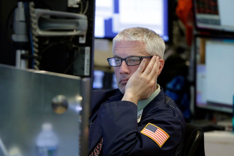 Trader Mark Zifchak works on the floor of the New York Stock Exchange on Wednesday. The quick daily swings that now seem commonplace can make things dicey for investors trying to time their trades.