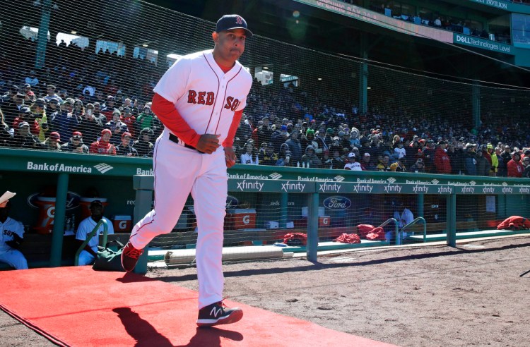 Boston Red Sox Manager Alex Cora runs onto the field as he is introduced during ceremonies before Thursday's home opener against the Tampa Bay Rays at Fenway Park in Boston.