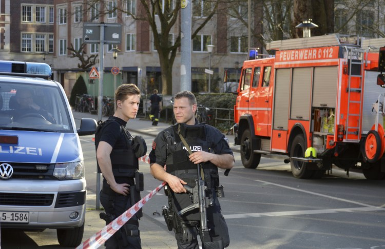 Police officers secure the crime scene after a van crashed into a group of people in Muenster, Germany, on Saturday.