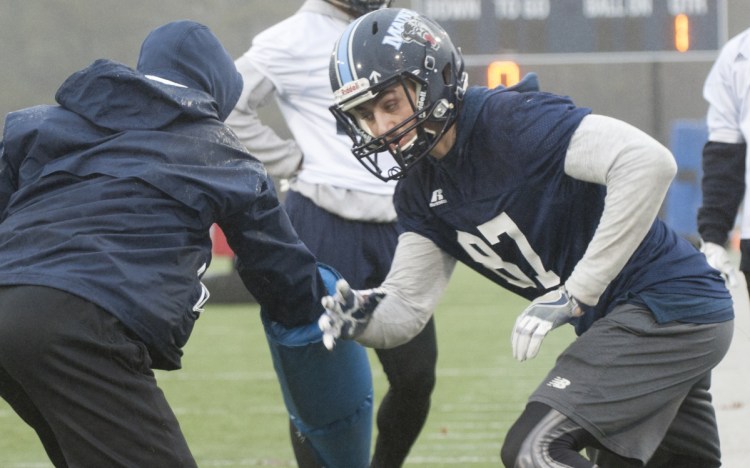 A graduate of Foxcroft Academy, Hunter Smith, right, is trying to earn playing time on the University of Maine football team. The Black Bears' coaching staff has made recruiting an in-state player like Smith a priority.