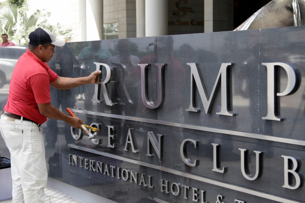A worker removes lettering from a marquee at the former Trump Ocean Club International Hotel & Tower in Panama City, Panama, where Trump management was evicted.