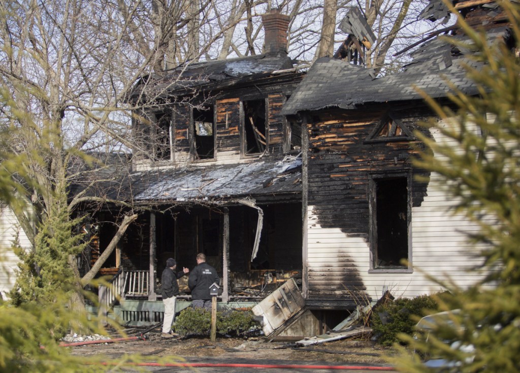 CAPE ELIZABETH, ME - APRIL 10: State fire marshals survey the aftermath of a fire that destroyed a home at 51 Ocean House Road in Cape Elizabeth on Tuesday morning. (Staff photo by Brianna Soukup/Staff Photographer)