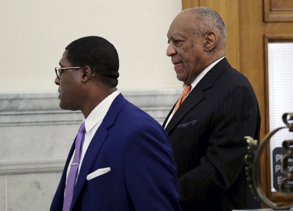 Actor and comedian Bill Cosby, right, arrives for his sexual assault retrial at the Montgomery County Courthouse in Norristown, Pa., on Tuesday.