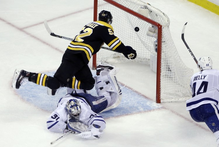 Bruins center Sean Kuraly scores against Toronto goaltender Frederik Andersen during the third period of Game 1 of their first-round playoff series Thursday in Boston. The Bruins won 5-1.