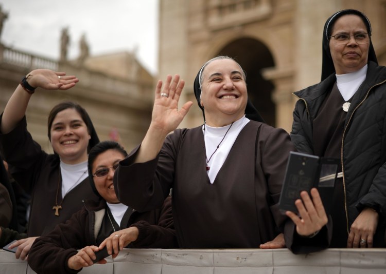 Nuns greet Pope Francis in St. Peter's Square. The issue of women's roles in the church is a recurring theme.
