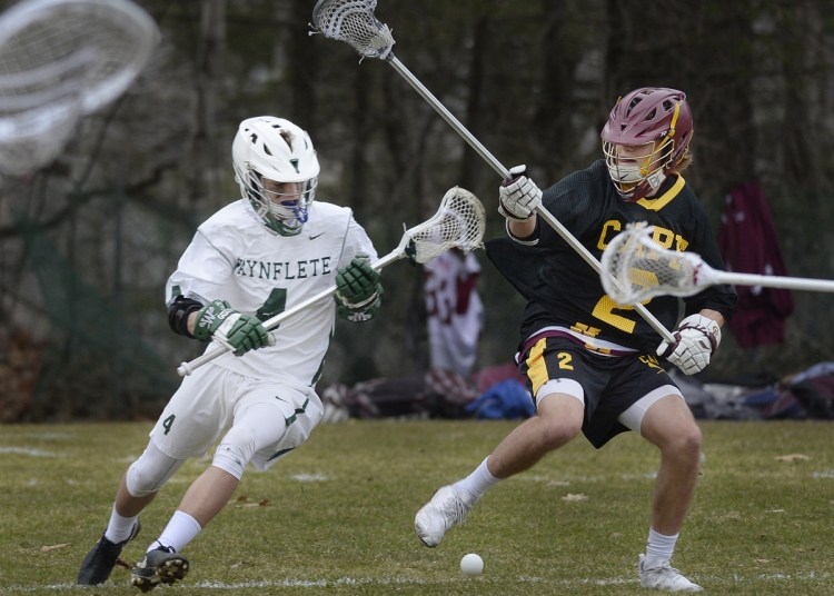 Oliver Burdick of Waynflete, left, and Max Patterson of Cape Elizabeth compete for a loose ball Friday during their boys' lacrosse opener in Portland. Cape Elizabeth came away with an 18-9 victory.