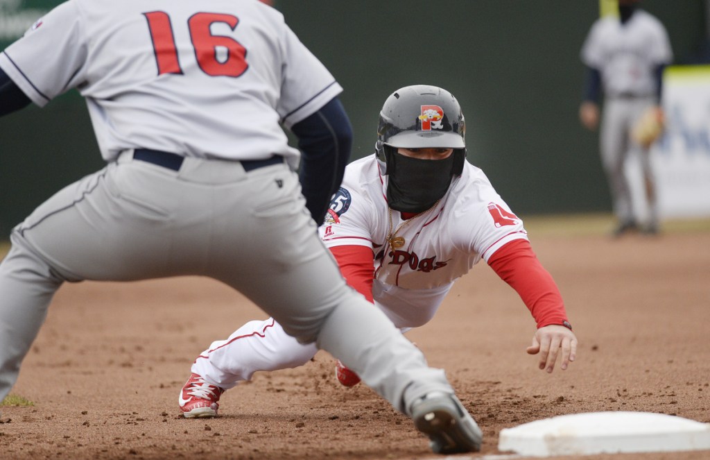 Portland's Esteban Quiroz dives back to first base on a pickoff attempt during Saturday's 3-0 win over the Binghamton Mets.