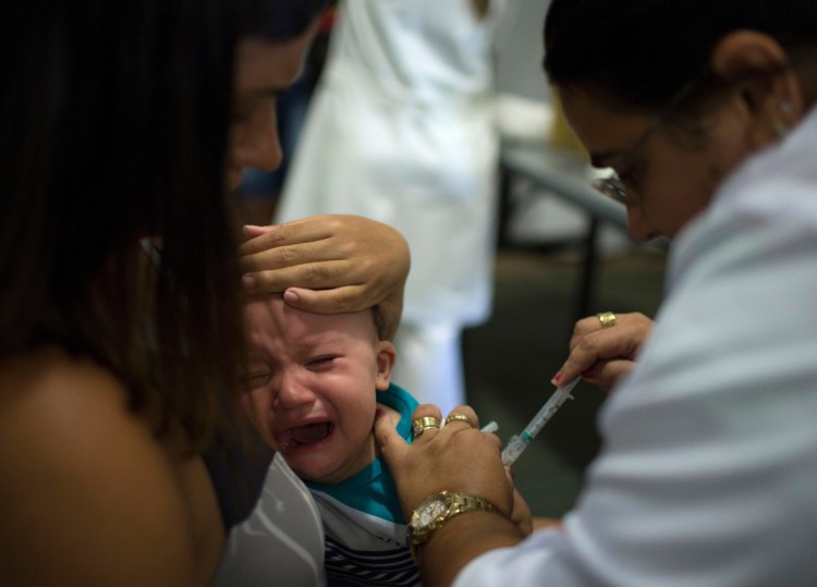 A health worker vaccinates a baby against yellow fever at a field hospital in Casimiro de Abreu, Brazil. The current outbreak has infected 1,127 people and 331 have died.
