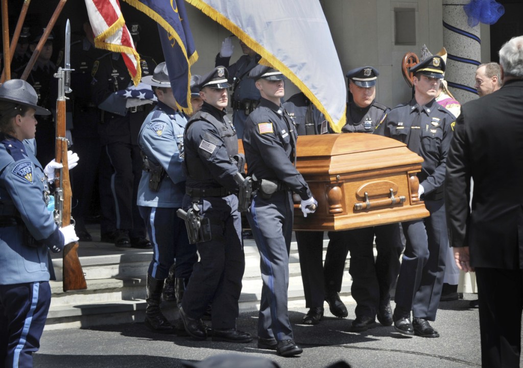 Police carry the coffin of K-9 Officer Sean Gannon after a funeral service Wednesday in Yarmouth, Mass.