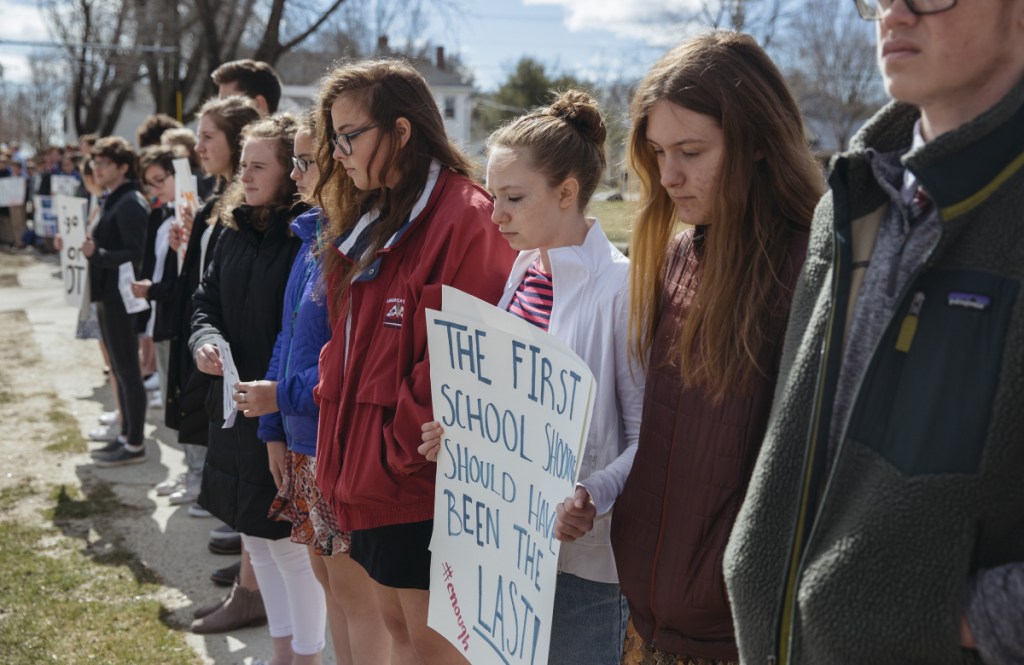North Yarmouth Academy sophomores, from right, Will Tatge, Eliza Tod, Bronwen Ramsey-Brimberg and Afton Morton joined about 100 students from the school who lined Main Street in Yarmouth for 13 minutes Friday in a protest against gun violence on the  anniversary of the 1999 school shootings that claimed 13 people in Littleton, Colorado.