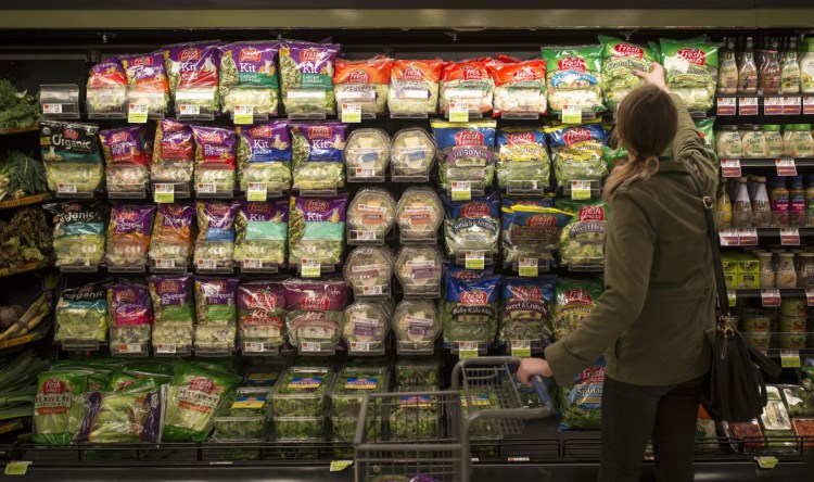 Sarah Moak grabs a bag of pre-packaged romaine lettuce hearts from a shelf in the South Portland Hannaford off of Cottage Road. Moak said that she trusts Hannaford to make sure their romaine is safe. 
