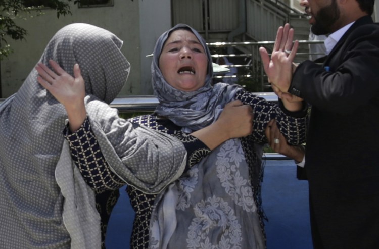 A woman cries at a hospital after she lost her son in a suicide attack on a voter registration center in Kabul, Afghanistan, on Sunday.