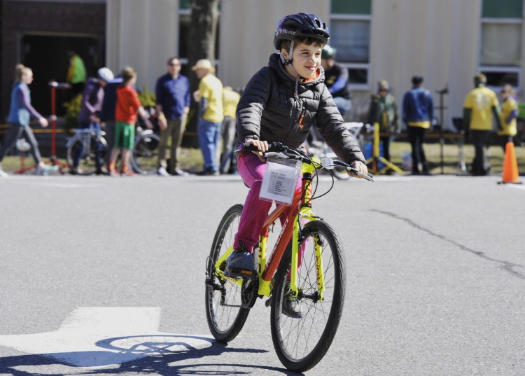 Ren Kauffunger, 9, of Arrowsic tests his bike of choice at the Bicycle Coalition of Maine's annual Great Maine Bike Swap held at the University of Southern Maine in Portland on Sunday.