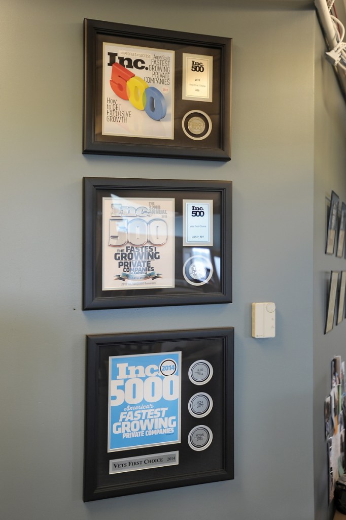 Fortune 500 awards from recent years hang on a wall of Portland-based Vets First Choice.