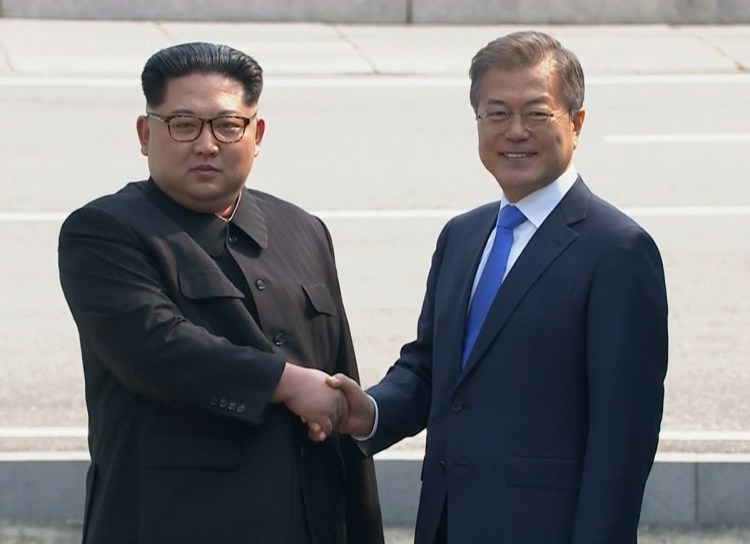 North Korean leader Kim Jong Un, left, shakes hands with South Korean President Moon Jae-in on Friday.