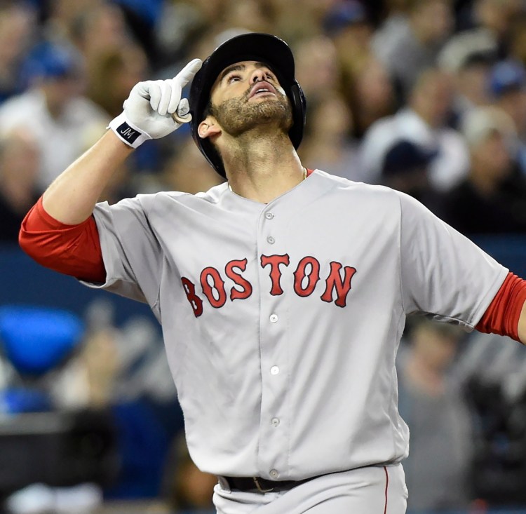 J.D. Martinez of the Boston Red Sox reacts Thursday night after hitting a three-run homer in the fifth inning of the 5-4 victory against the Toronto Blue Jays.