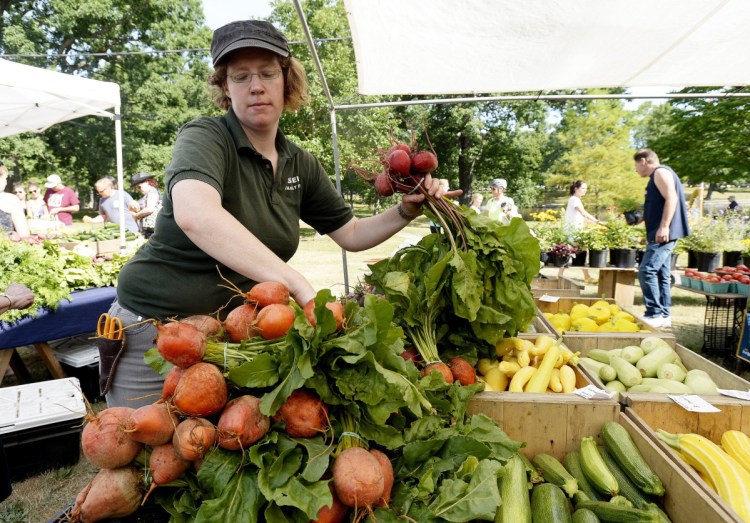 Carolyn Snell of Snell Farm puts out beets at Deering Oaks farmers' market in 2016. The market moves outdoors for the season beginning this weekend.