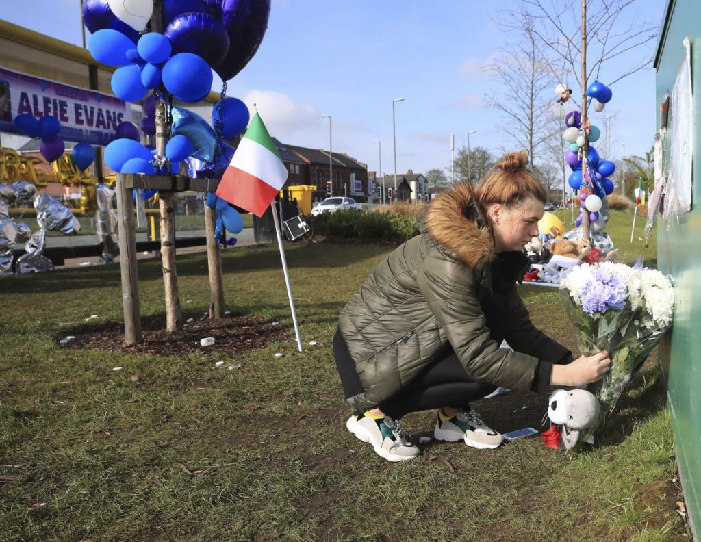 A woman leaves flowers outside Alder Hey Children's Hospital in Liverpool, England, following the death of 23-month-old, Alfie Evans on Saturday. Alfie Evans, the sick British toddler whose parents won support from Pope Francis during a protracted legal battle over his treatment, died early Saturday. He was 23 months old.