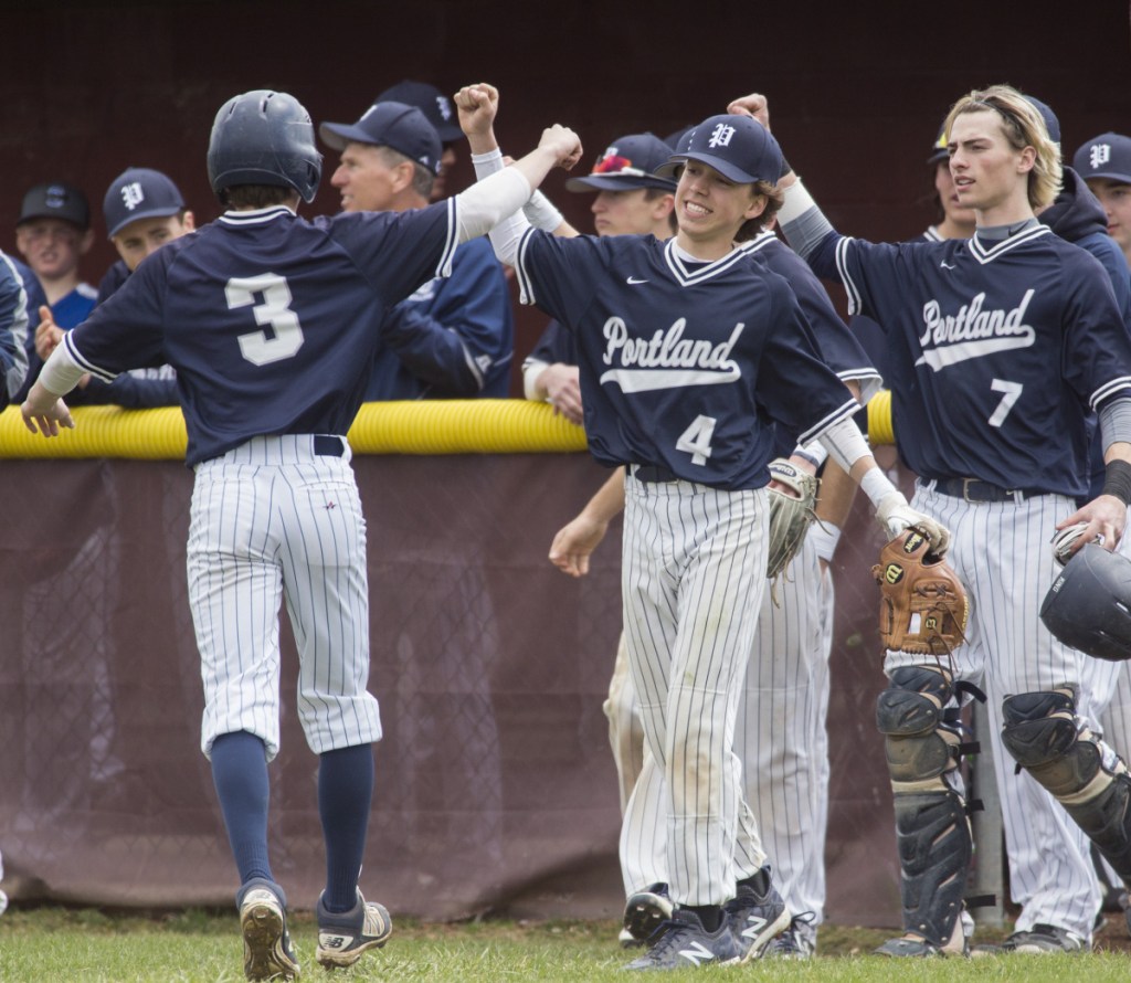 Portland players congratulate junior Ben Stasium, 3, after he scores a run during Portland's 8-1 win over Thornton Academy on Saturday in Saco.