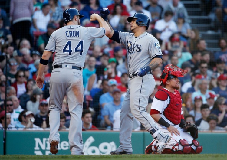 Tampa Bay's Wilson Ramos, center, celebrates his two-run homer with C.J. Cron as Boston's Christian Vazquez kneels behind home plate in the third inning of the Rays' 12-6 win Saturday in Boston.