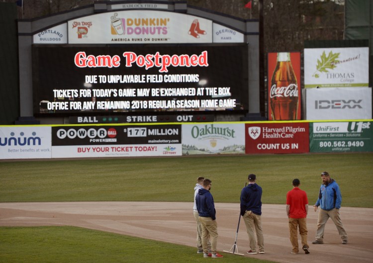PORTLAND, ME - APRIL 30: The grounds crew looks over the infield shortly after the Portland Sea Dogs postponed their game Monday, April 30, 2018. (Staff photo by Shawn Patrick Ouellette/Staff Photographer)