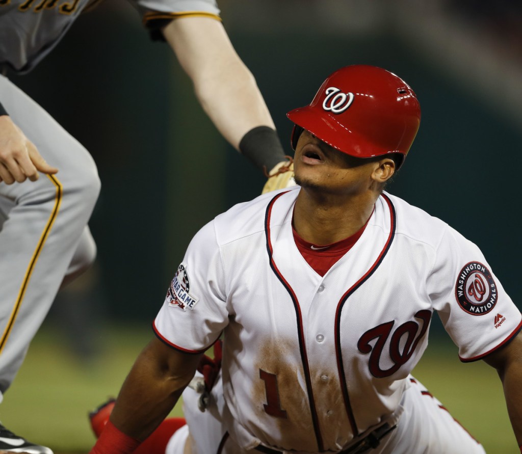 Wilmer Difo of the Washington Nationals looks up Monday night after sliding back into third base on a failed pickoff attempt by the Pittsburgh Pirates in the fourth inning. Washington came away with a 3-2 victory at home.