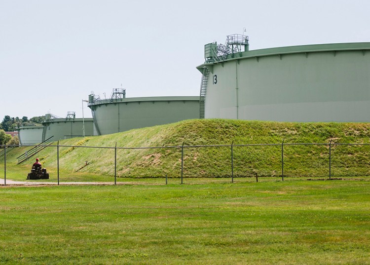 A mower cuts the grass at the Hill Street tank farm in 2015 in South Portland.