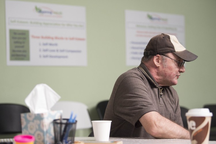 Kevin Horton sits at a table for a snack during an open house Thursday at the new National Alliance on Mental Illness peer recovery center in Waterville. The center offers support groups and classes to help those confronted by mental health or substance abuse challenges.