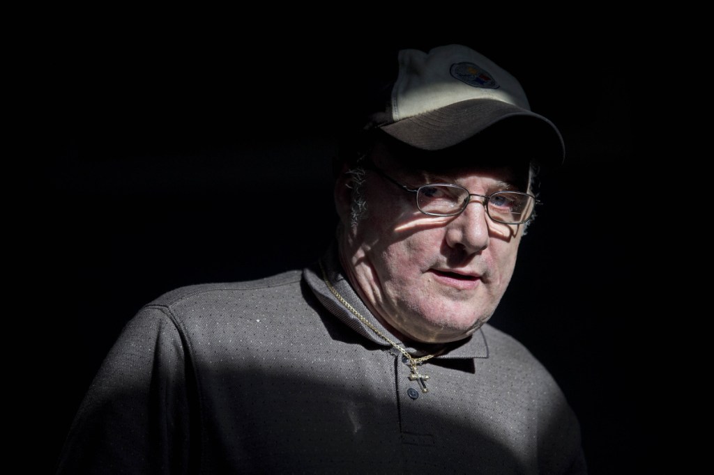 Kevin Horton stands in a sliver of light Thursday during an open house at the new National Alliance on Mental Illness peer recovery center in Waterville. The center offers support groups and classes to help those confronted by mental health or substance abuse challenges.