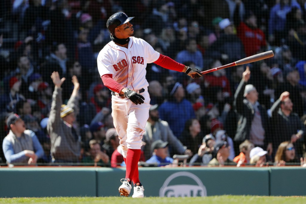 Boston Red Sox shortstop Xander Bogaerts watches his grand slam during the second inning against the Tampa Bay Rays on Saturday at Fenway Park in Boston. The Red Sox won 10-3.