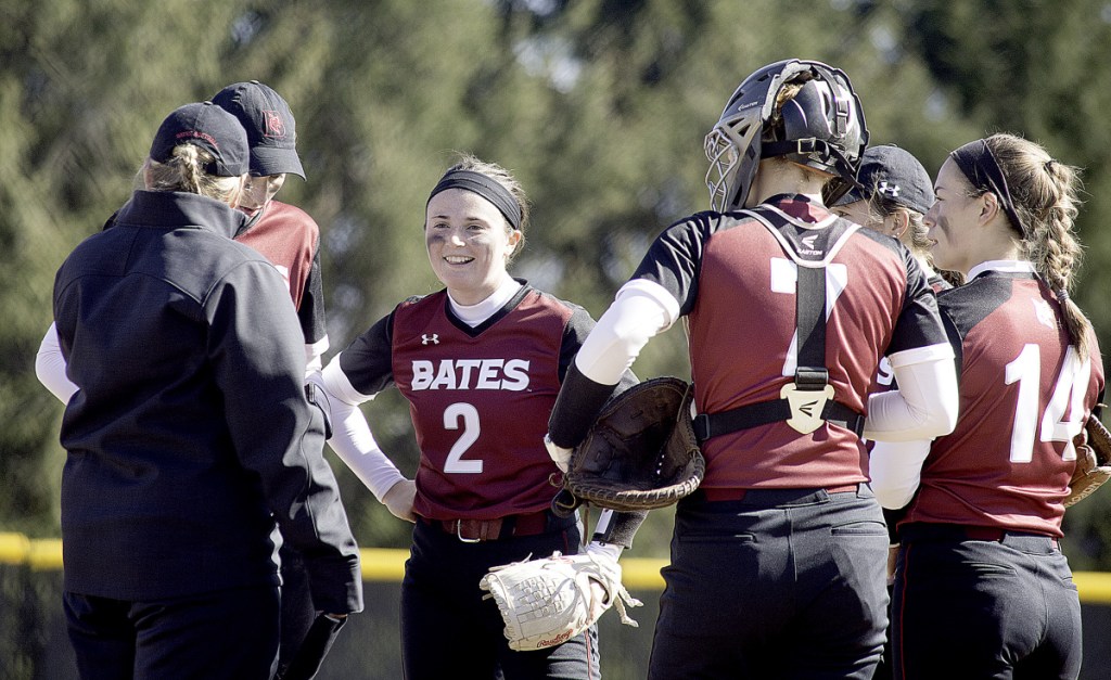 Sun Journal photo by Daryn Slover 
 Bates College pitcher Kirsten Pelletier (2) talks with her coach and teammates during Saturday's doubleheader against Tufts in Lewiston.