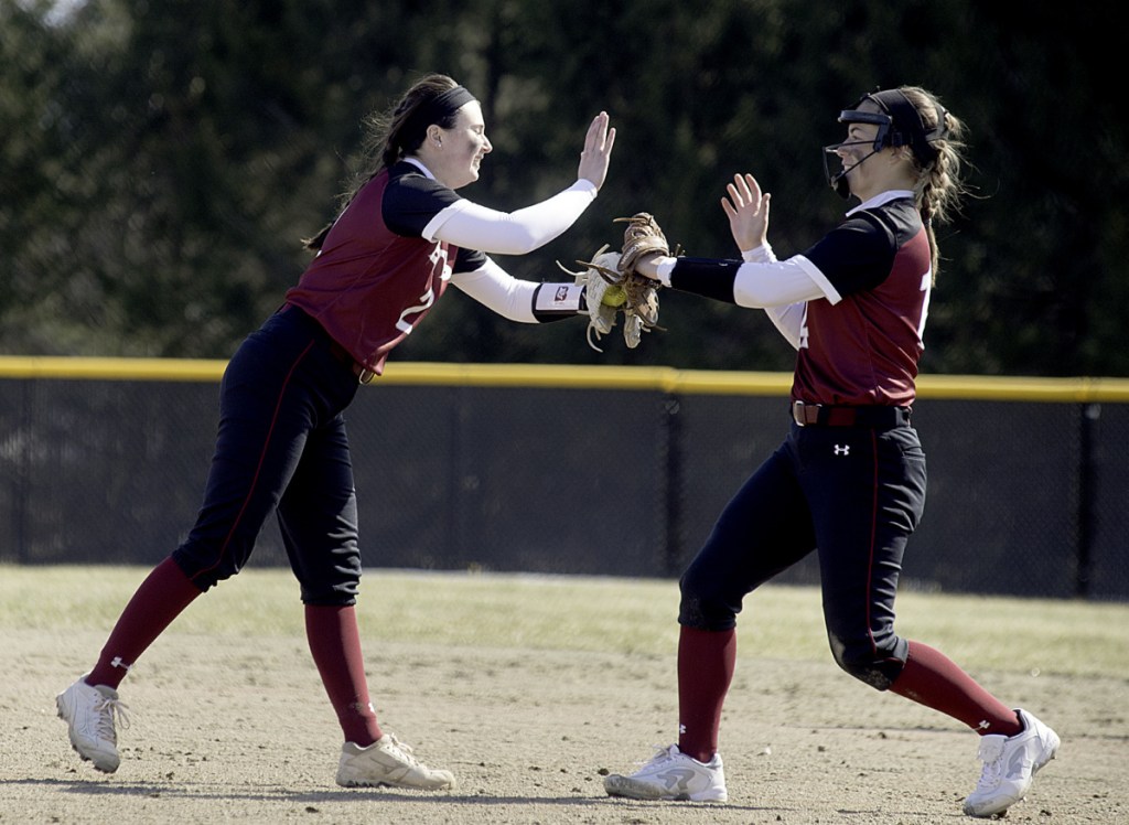 Sun Journal photo by Daryn Slover 
 Bates College pitcher Kirsten Pelletier, left, gives Payton Buxton a high five to close out the inning against Tufts on Saturday in Lewiston.