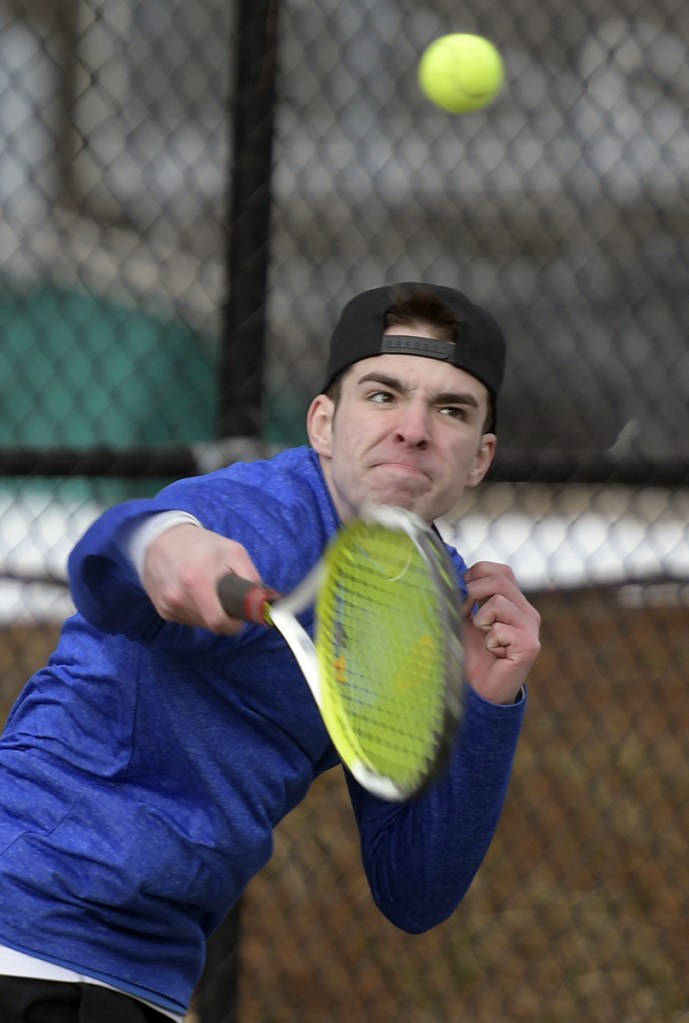 Maranacook's Micah Charette returns a serve during practice Tuesday in Readfield.