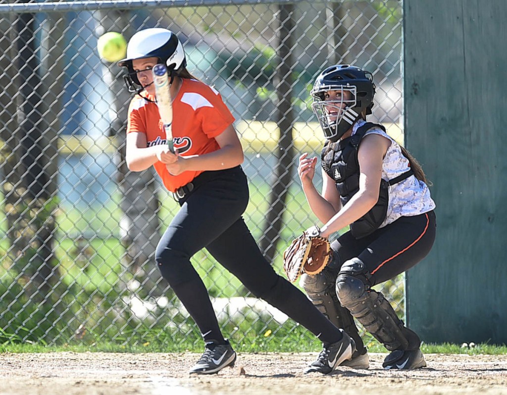 Full contact: Gardiner's Kylie Sirois connects on a pitch from Winslow's Broghan Gagnon during a game last season in Winslow.