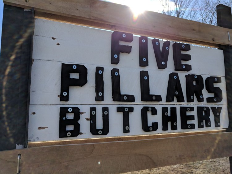 The sign advertising Hussam Al Rawi's butchery in Troy had eight holes shot into it Sunday, shortly after he put it up.