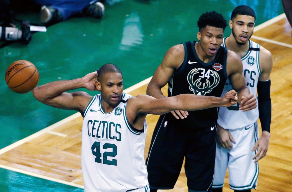 AP photo
Boston's Al Horford (42) and Milwaukee's Giannis Antetokounmpo (34) react to a call during the fourth quarter of Game 1 of a first-round playoff series Sunday in Boston. The Celtics won 113-107 in overtime.