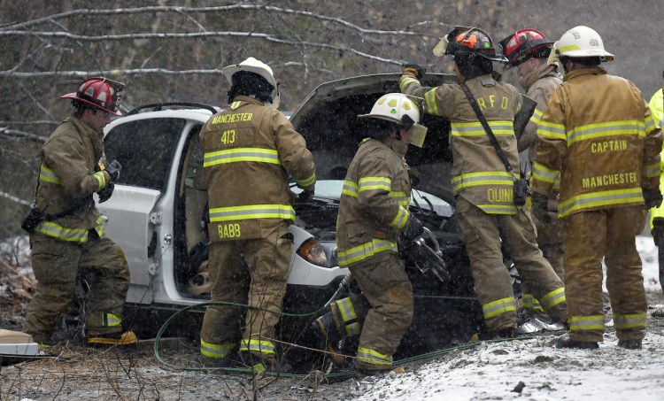 Firefighters and EMS workers extricate the driver of an SUV involved in a head-on collision Monday on Granite Hill Road in Manchester. The driver of the other vehicle fled the scene, according to Kennebec County Sheriff's Deputy Sgt. Mike Dutil, after the Pontiac he had been driving was disabled in the accident. The driver of the SUV was transported to a local hospital, Dutil said, and police were searching for the other driver.
