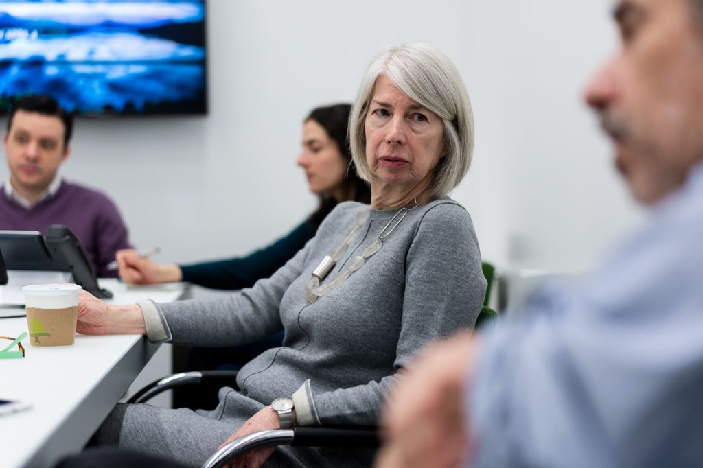 Rebecca Corbett, Colby class of 1974, confers with colleagues at the New York Times during a recent news meeting.