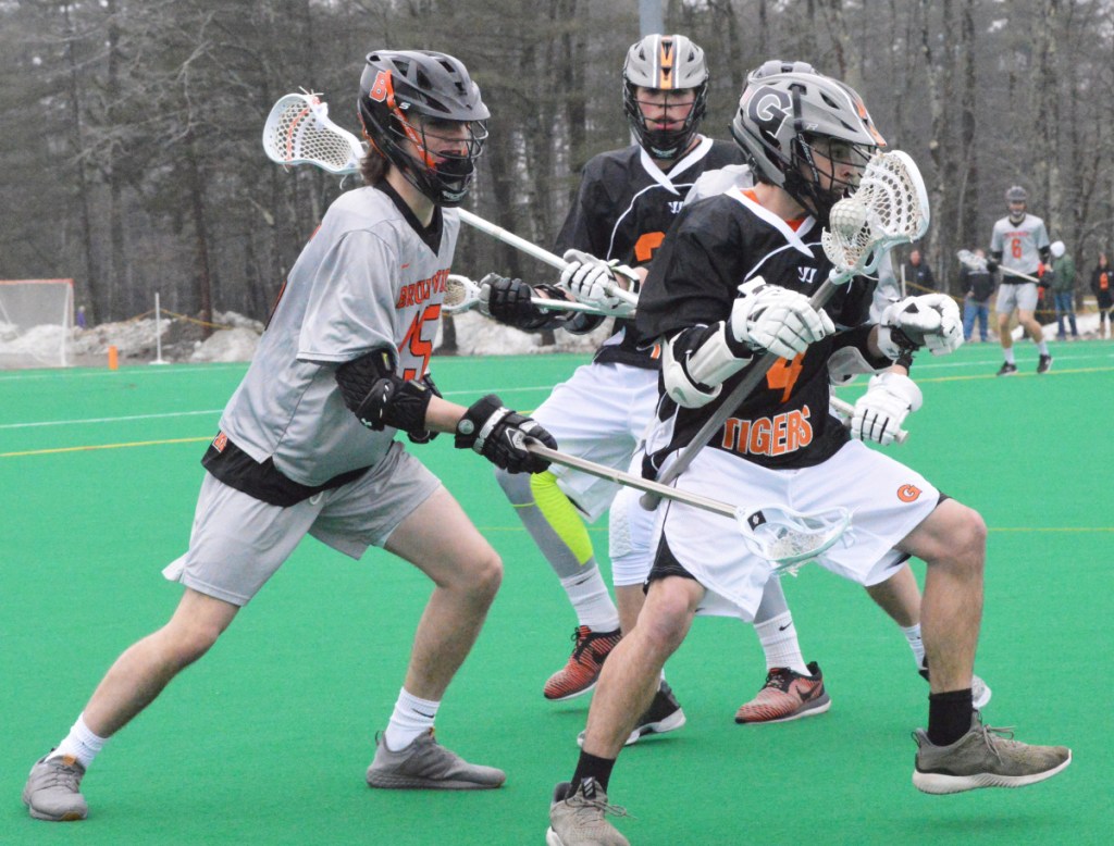 Gardiner's Nathan Phillis (4) tries to pull away from Brunswick's Colin MacKinnon (15) on Tuesday at Bowdoin College in Brunswick.