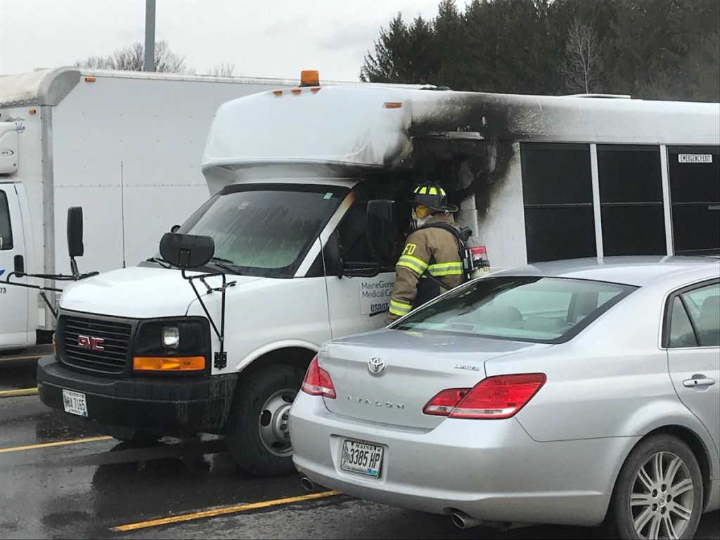 Lt. Jason Mills, of the Augusta Fire Department, looks inside a shuttle bus that caught fire Tuesday on the Augusta campus of MaineGeneral Medical Center.