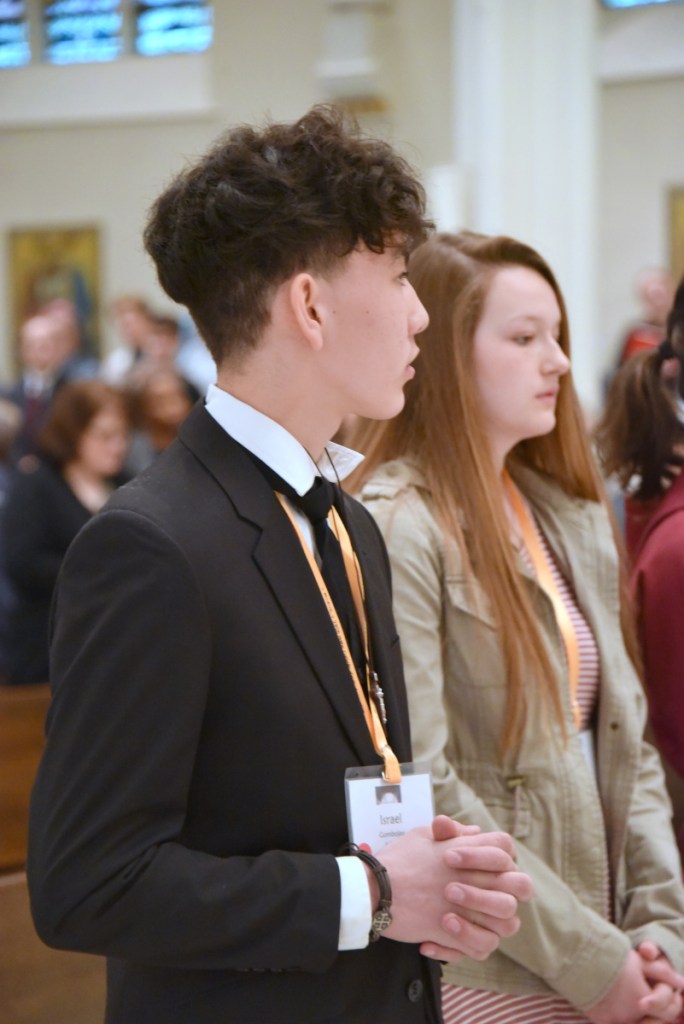 Israel Gombojav, left, from Corpus Christi Parish in Waterville, at the Mass during the convention celebrated by Bishop Robert P. Deeley at the Cathedral of the Immaculate Conception in Portland.