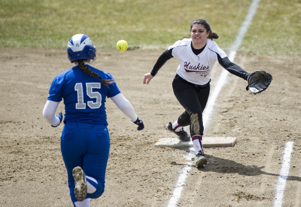 Lawrence's Molly Folsom (15) beats out the throw to Maine Central Institute first baseman Leah Bussell on Friday in Fairfield.