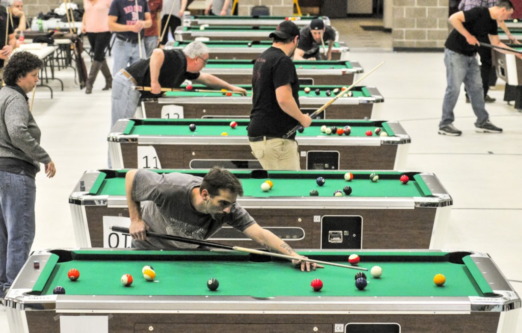 The top four finalist teams in three divisions compete on many tables during a pool tournament on Sunday in the Augusta Armory.