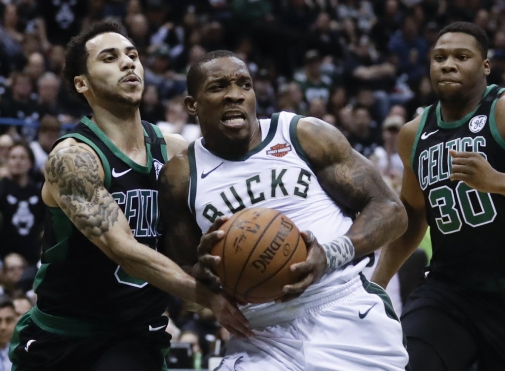 Milwaukee's Eric Bledsoe is fouled by Boston's Shane Larkin during the first half of Game 4 of a first-round playoff series Sunday in Milwaukee.