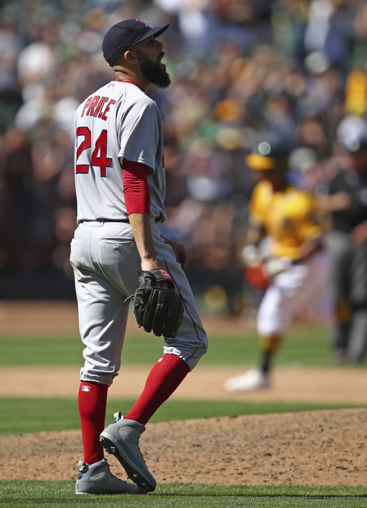 Boston pitcher David Price (24) walks back to the mound as he waits for Oakland's Khris Davis to run the bases after hitting a three-run home run in the eighth inning Sunday in Oakland, California.