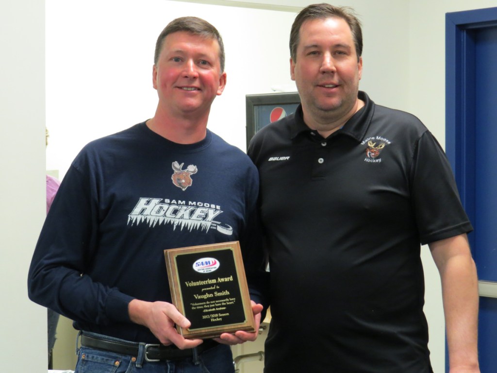An outstanding volunteerism award was presented to SAM hockey representative and long-time head coach Vaughn Smith, left, from West Gardiner, by Dan Foster, chair of the hockey committee during the annual meeting at the Camden National Bank Ice Vault in Hallowell.