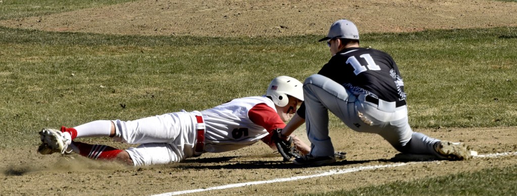 Bridgeway's Eric Wescott (11) attempts to tag out Hall-Dale's Austin Stebbins at third base during a Mountain Valley Conference game Monday in Farmingdale.