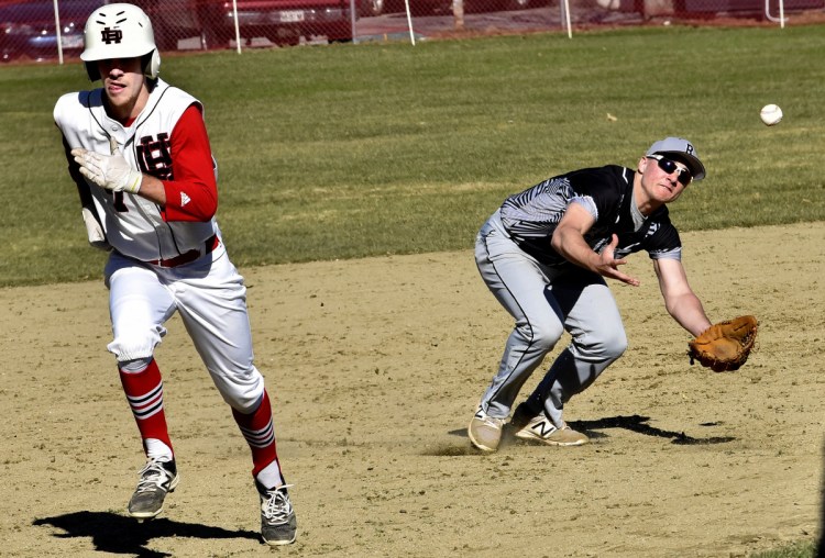 Bridgeway's Sean Whalen, right, fields the ball as Hall-Dale's Alec Byron runs to third base during a Mountain Valley Conference game Monday in Farmingdale.
