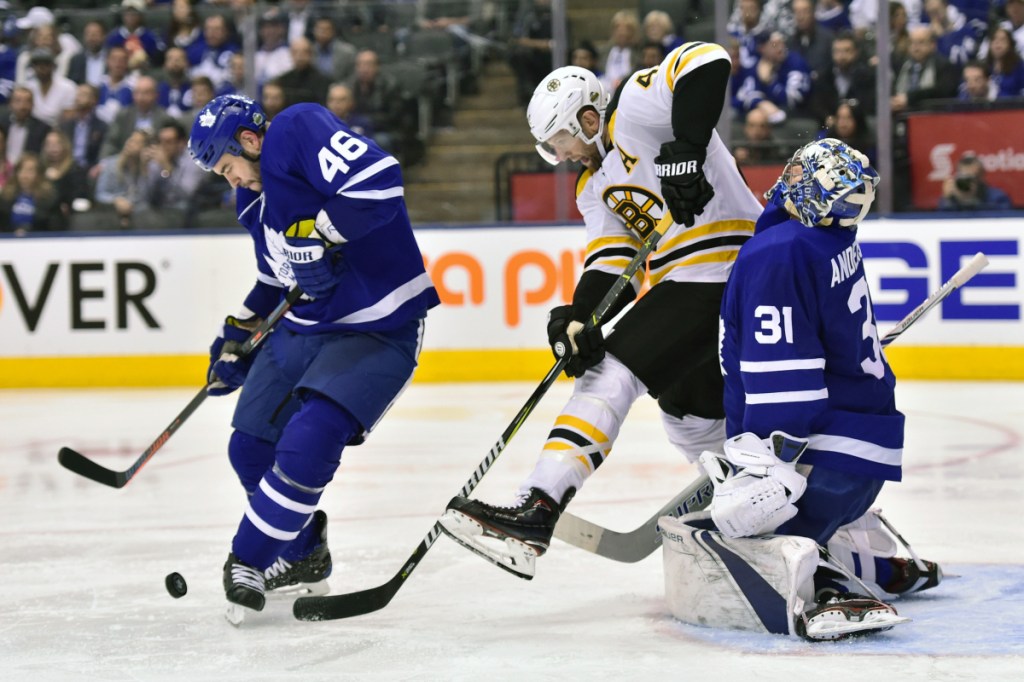 Boston Bruins right wing David Backes (42) picks up a penalty after Toronto Maple Leafs goaltender Frederik Andersen (31) takes an elbow to the head during third period Monday in Toronto. Leafs defenseman Roman Polak (46) looks to clear the puck.